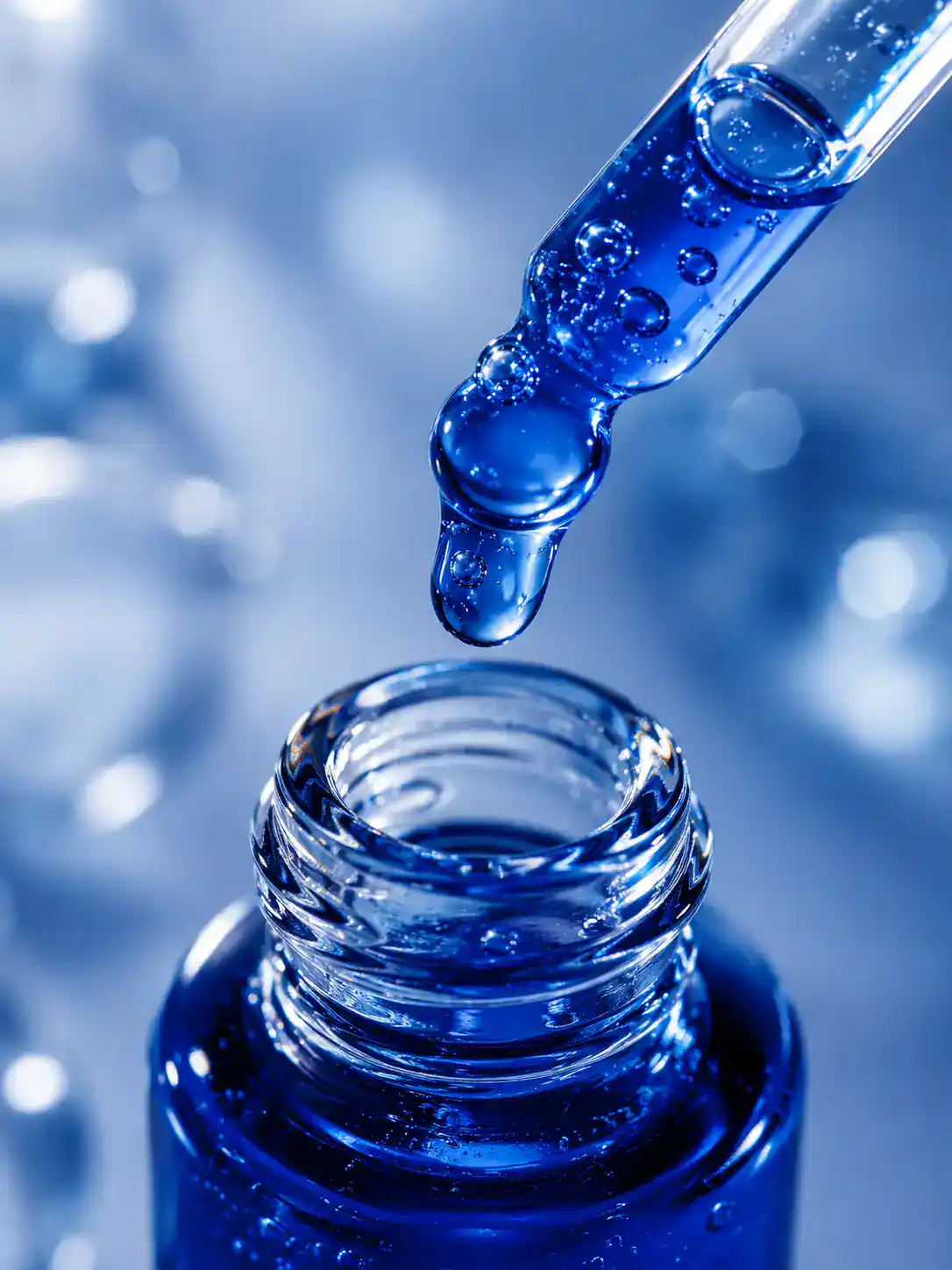Copper peptide scalp serum manufacturer Moe’s Group, blue GHK-Cu serum dispensed from a dropper